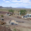 Behind the Aiken Mine weigh station, with Clark Mountain in the distance, rest the remains of two mobile homes