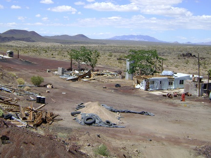 Behind the Aiken Mine weigh station, with Clark Mountain in the distance, rest the remains of two mobile homes
