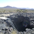 A recently installed sturdy metal ladder leads down into the Lava Tube