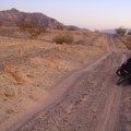 I ride a little further south on Old Kelso Road in the red light of sunset and stop before reaching the next dry wash