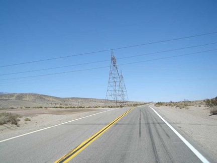 I stop at the power lines that cross Highway 127 ten miles out from Baker and am surprised that my cell phone still works