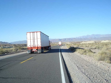 A couple of big rigs pass me as we all descend Highway 127 into the Tecopa Basin together