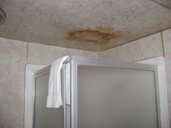 The stained ceiling in the bathroom tells a story of a shower in the room above that leaked