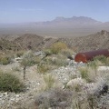 Outside the tunnel entrance on the flat area composed of tailings sits a big tank of some kind