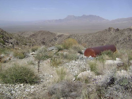 Outside the tunnel entrance on the flat area composed of tailings sits a big tank of some kind