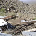 Debris from an old collapsed cabin, including its refrigerator, sits at the top of the road at Bighorn Basin Mine