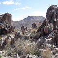 A row of vertical rocks outcrops above Barnett Mine frame a view of Table Mountain