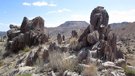 A row of vertical rocks outcrops above Barnett Mine frame a view of Table Mountain