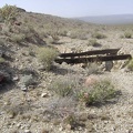 Two large timbers span the opening of a shaft at the second mine site