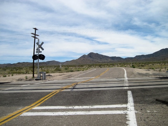 I've reached the pavement of Ivanpah Road, cross the tracks, then ride over to the abandoned house nearby