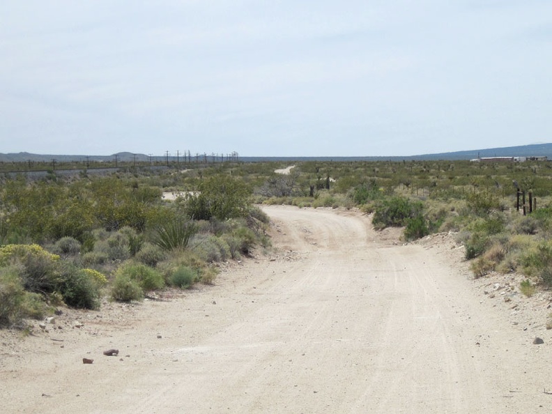 I remount the 10-ton bike, cross the tracks, and get back on the dirt road (now called  Brant Road on some maps)