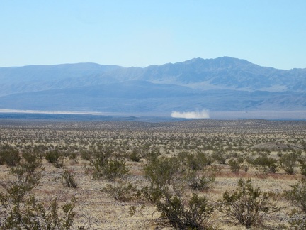 Off in the distance below, a puff of dust hovers