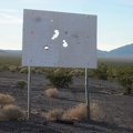 An old sign announcing a proposed toxic waste dump here at Broadwell Dry Lake has been appropriately well shot-up