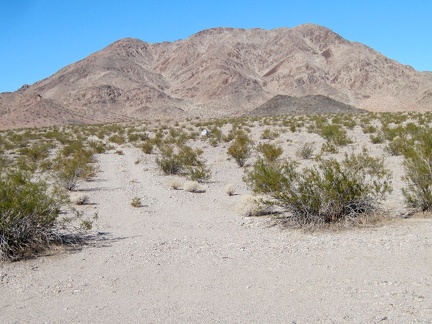 I turn back for a last look at my tent against a Cady Mountains backdrop before it disappears for the day