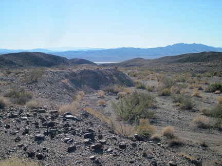 I pause to take in the views from this berm above Broadwell Natural Arch Wash, spared from erosion