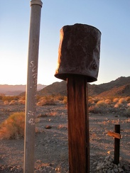 The fence post here is clearly old, but the adjacent upright plastic pipe clearly is not