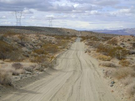 The hike begins with a 1.3 mile walk on the power-line road west of Kelso Dunes, which soon becomes quite sandy