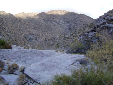 I climb over a granite platform as I head further up Bull Canyon