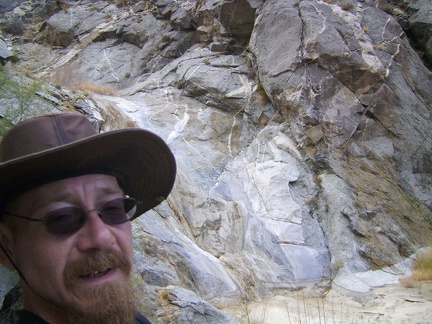 I take an energy-bar break up on a rock pile overlooking the Bull Canyon dry waterfall, at about 3450 feet elevation