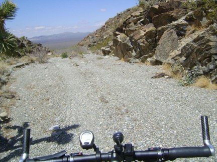 Pachalka Spring Road drops down a hill at the bottom of the small wash canyon