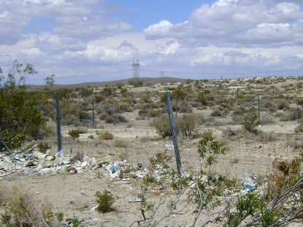 Closer to I-15, a fence along Excelsior Mine Road traps a lot of windblown garbage from freeway drivers