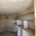 Inside the dirt-floor Rock Tank dugout, sturdy old shelves remain