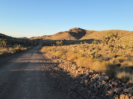 The wash I've been following arrives at Ivanpah Road, so I cross it, and begin hiking the old railway grade