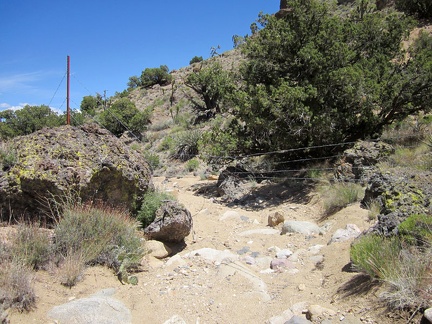 Hiking down this Castle Peaks wash is fun (it's a bit downhill), and then I reach this fairly recent barbed-wire fence