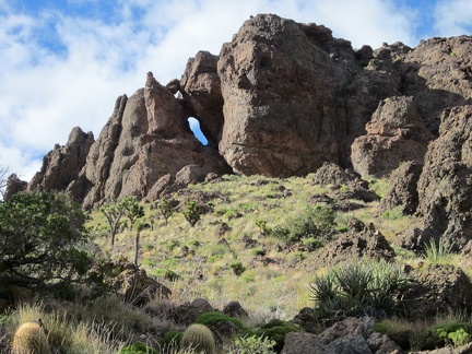 I notice a natural arch in the Castle Peaks pinnacles as I start my way down the hill