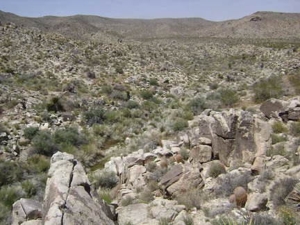I climb up an adjacent boulder pile at Coyote Springs to start my walk back to the tent 1/2 mile down the road
