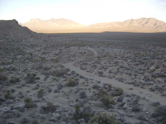 I leave the Coyote Springs stream and climb up one of the low rocky hills along the old road on the way back to my bike