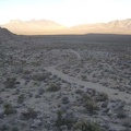 I leave the Coyote Springs stream and climb up one of the low rocky hills along the old road on the way back to my bike