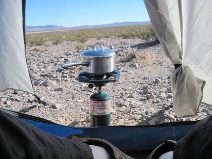 The wind has picked up, and my water just won't boil, so I bring my propane burner closer to my tent, hoping to block the wind