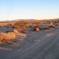 I watch the sun go down on the Bristol Mountains while I ride alongside Broadwell Dry Lake
