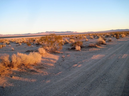 I watch the sun go down on the Bristol Mountains while I ride alongside Broadwell Dry Lake