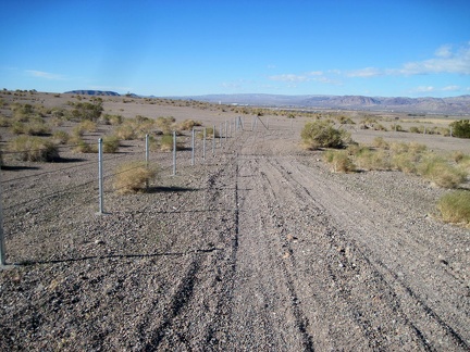 I return to the 10-ton bike and coast down the gravel road past a recently built fence