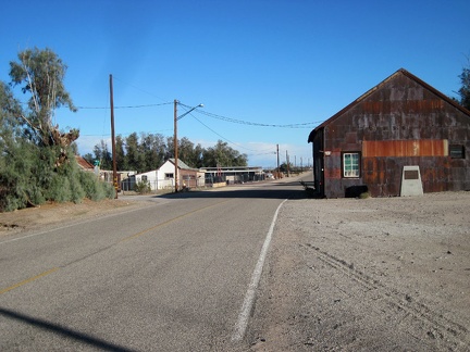 An old metal-clad garage-type building sits just down the street from the Daggett Stone Hotel