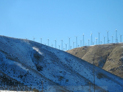 I see a dusting of snow as my Amtrak bus passes through the Tehachapi Mountains and its wind turbines; this was a good trip
