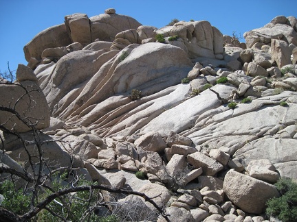 I climb up the eroded rock in the upper area of the Eagle Rocks, Mojave National Preserve