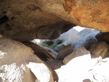 Rock-scrambling at Mojave National Preserve's Eagle Rocks can include scrambling under boulders, not just over them