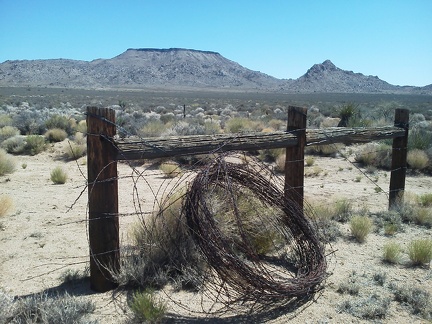 More remnants of barbed-wire removal along Woods Wash Road, with Table Mountain and one of the Twin Buttes in the background