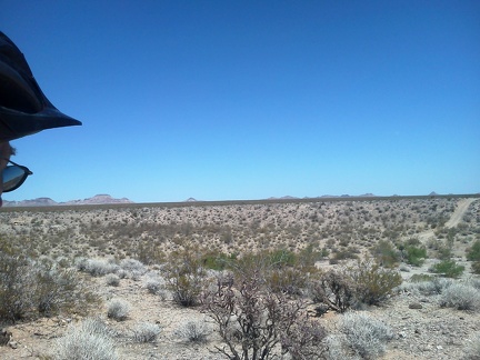 As the road crosses Watson Wash ahead, I run across a rancher in a pick-up truck on the way up that hill over there