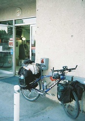 The 10-ton bike and its sore knee take a break at the Shoshone general store and gas station