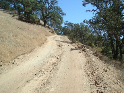 Poverty Flat Road rises steeply out of Poverty Flat