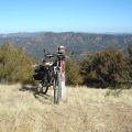 Bike standing on the edge of County Line Road at the trailhead of the Hartman Trail (closed to bikes)