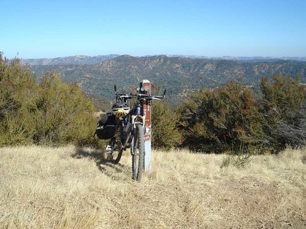 Bike standing on the edge of County Line Road at the trailhead of the Hartman Trail (closed to bikes)