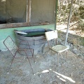 Nice cool water is piped from the spring into this big Rubbermaid tub. Two creaky chairs invite visitors, sort of.