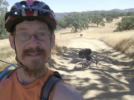 Rising up Manzanita Point Road toward Park Headquarters. A small low-flying airplane passes overhead.