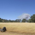 I reach a flat area on Manzanita Point Road and see smoke not far away; looks like a brush fire in Henry Coe State Park.