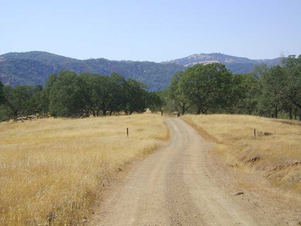 Beyond the chamise chapparal, Coit Road crosses grassland and eventually becomes Mahoney Meadows Road